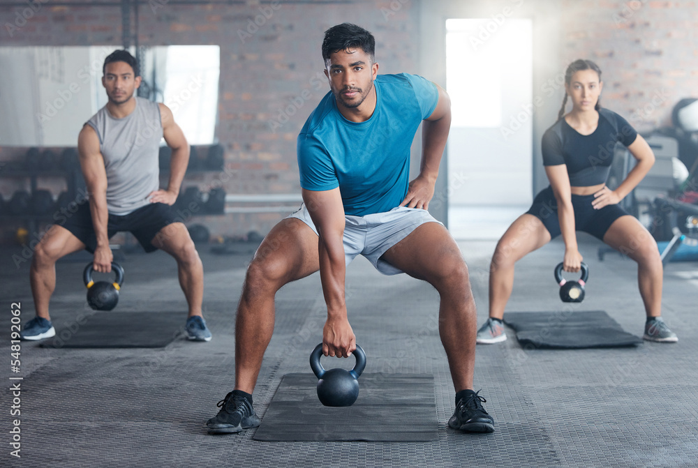 Fitness, kettlebell weight and people doing an exercise for strength, wellness or health together in a gym. Sports, motivation and athletes doing a squat workout with personal trainer in sport studio Fitness, kettlebell weight and people doing an exercise for strength, wellness or health together in a gym. Sports, motivation and athletes doing a squat workout with personal trainer in sport studio