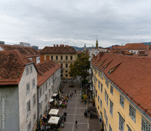 view of the rooftops of the old centre of Graz with the Schlossberg Square below photo