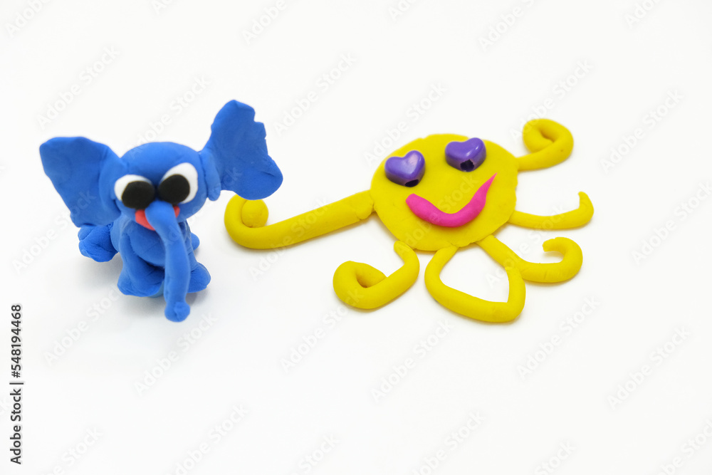 Child created elephant and sun from plasticine, colorful modeling clay and sculpting funny animals . Home Education game with clay. Early development .