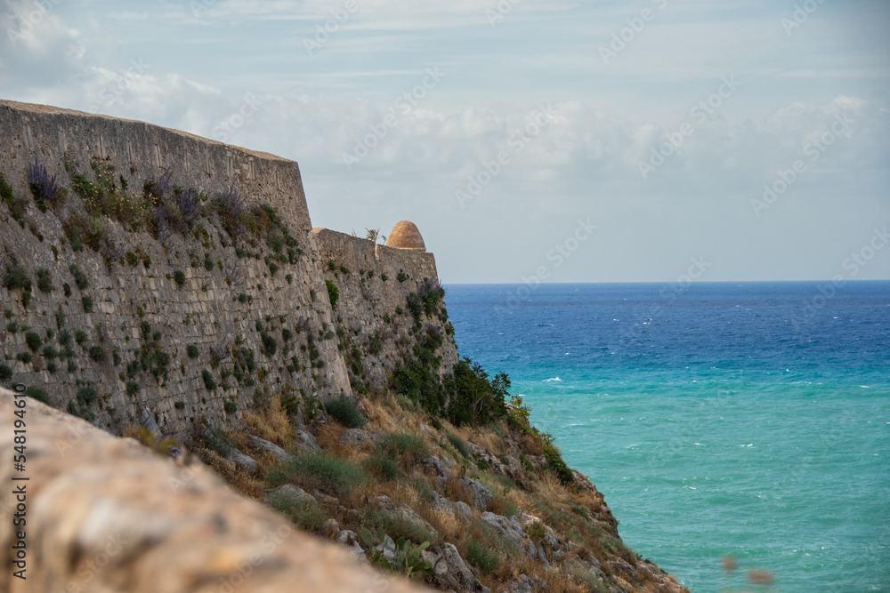 The wall of the Fortezza fortress ruins in Rethymno and the sea