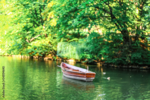 View of beautiful river with boat and green trees