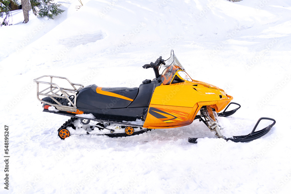 modern snowmobile scooter vehicle on snow in mountain road.rental automobile extreme sport adventure