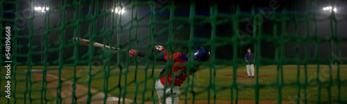 Canvas Print Portrait of Caucasian kid boy baseball player practicing hits on a rainy evening