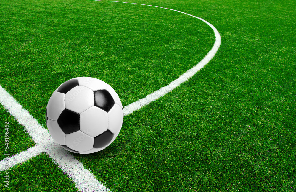 Fototapeta premium Soccer ball on stadium field texture