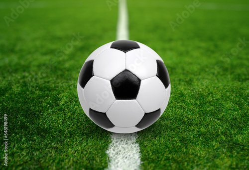 Soccer ball on stadium field texture © Alekss