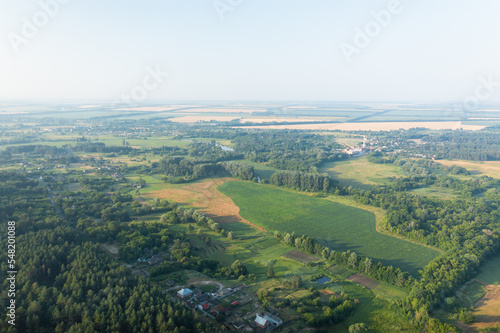The countryside from the height is a green ecological area. Summer panorama of the countryside among the green trees - aerial drone shot. © Andrii Chagovets