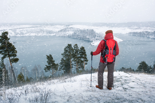 caucasian male hiking in mountains in winter season. wanderlust adventure concept winter vacations