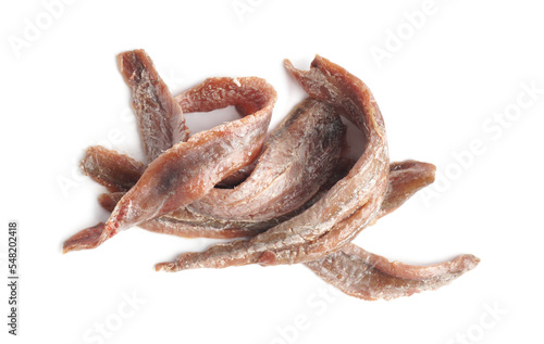 Heap of delicious anchovy fillets on white background, top view