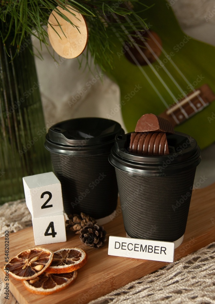 Waiting for Christmas, warm drink in glasses and chocolate. December 24 is on the calendar Waiting for Christmas, warm drink in glasses and chocolate. December 24 is on the calendar