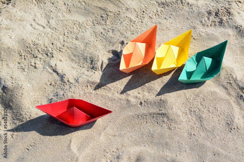 Many paper boats on sandy beach, above view Many paper boats on sandy beach, above view