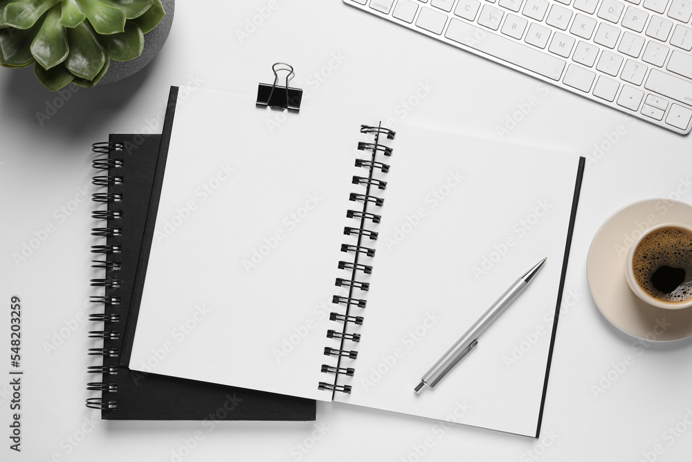 Flat lay composition with stylish notebooks on white table Flat lay composition with stylish notebooks on white table