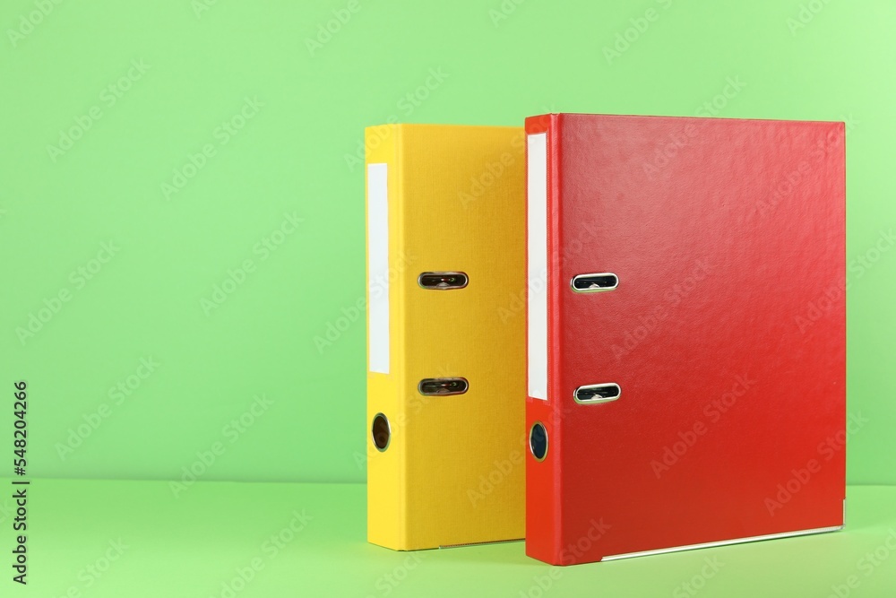 Office folders on light green background, space for text Office folders on light green background, space for text