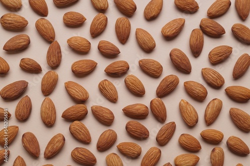 Delicious raw almonds on beige background, flat lay