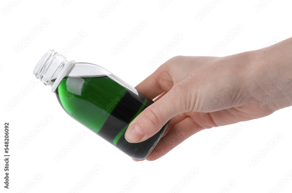 Woman pouring syrup from bottle isolated on white, closeup. Cough and cold medicine Woman pouring syrup from bottle isolated on white, closeup. Cough and cold medicine