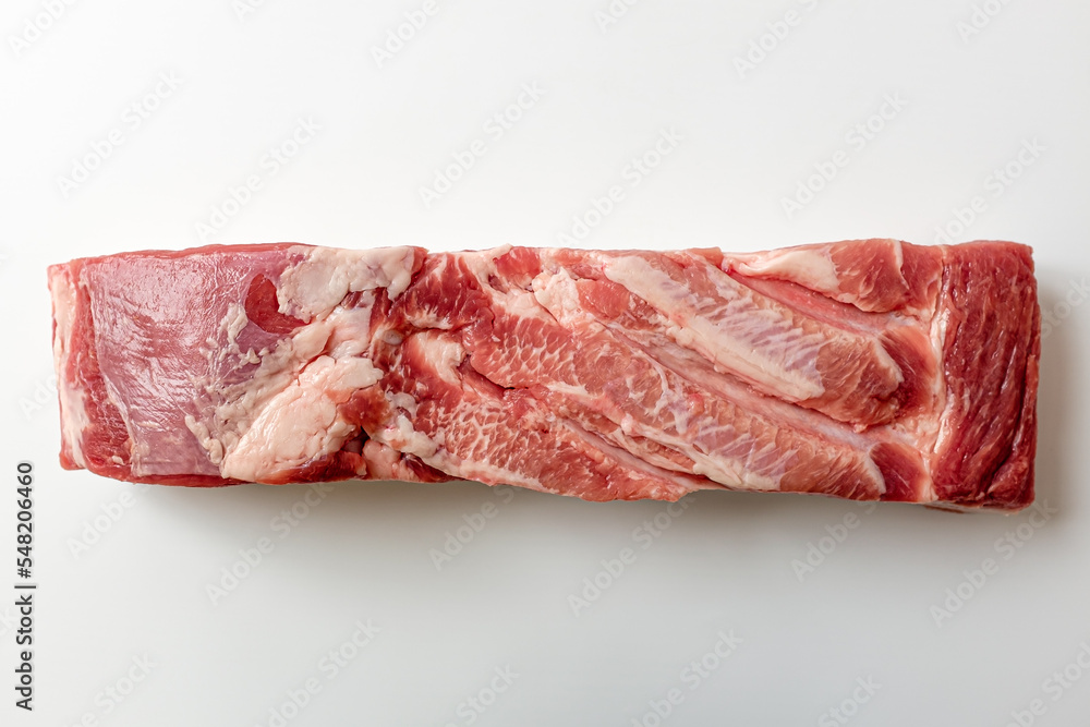 Whole pork belly on a white background