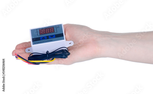 Industrial temperature controller in hand on white background isolation photo