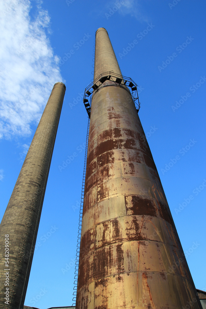 Tall, metal industrial smokestack