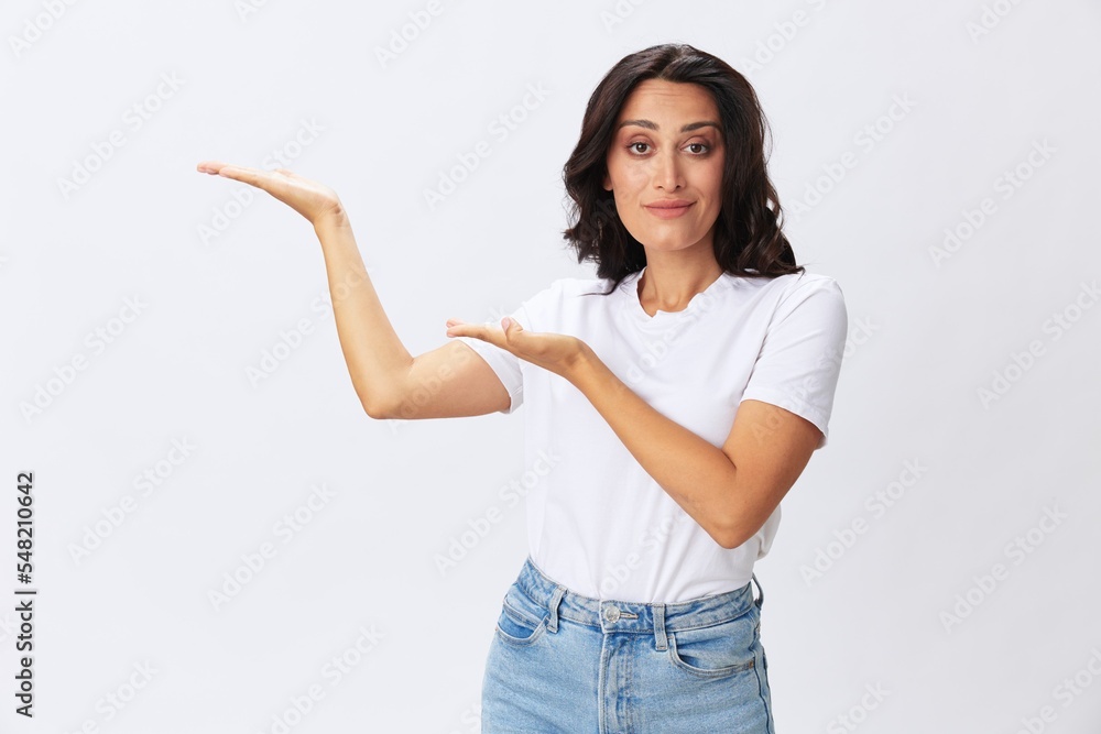 Woman smile and happiness shows a finger on the background, hand gestures, in a white t-shirt on a white background, copy space Woman smile and happiness shows a finger on the background, hand gestures, in a white t-shirt on a white background, copy space