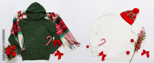 Banner Close up green, white blank template hoodie copy space. Christmas Holiday concept. Top view set mockup hoodie, scarf, hat. Red holidays decorations background. Happy New Year accessories.