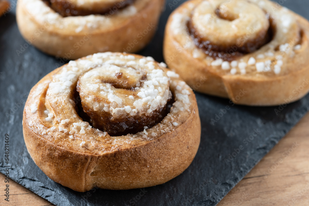 Cinnamon rolls buns on wooden table. Kanelbulle Swedish dessert Cinnamon rolls buns on wooden table. Kanelbulle Swedish dessert