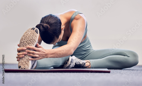 Yoga, fitness and stretching woman on floor for body wellness, exercise and healthy lifestyle with wall mockup for marketing. Sports athlete girl with foot or sneakers in cardio, pilates and workout