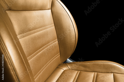 Modern luxury orange leather interior. Part of red leather car seat details with stitching. Interior of prestige car. Comfortable brown perforated leather seats. Perforated leather. © Aleksei