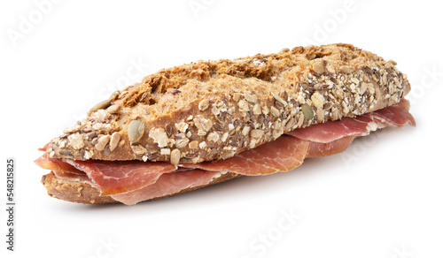 Ham baguette sandwich on wooden cutting board, white background, closeup.