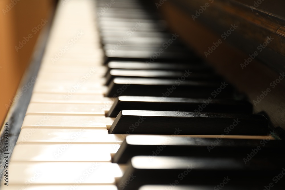 Modern piano with black and white keys, closeup