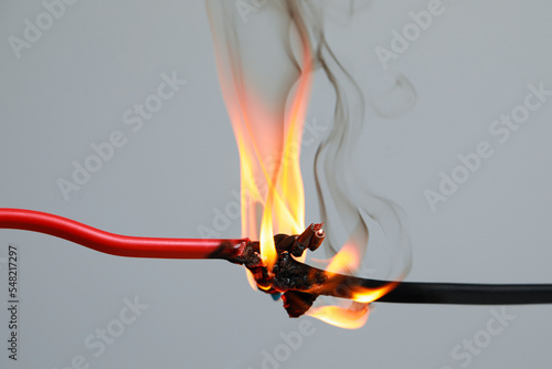 Obraz na płótnie Inflamed red wire on grey background, closeup