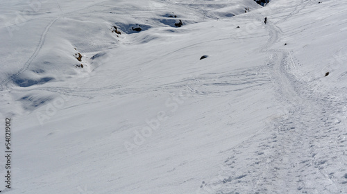 a trail in the snow a beautiful sunny day in the winter snowy mountains © corradobarattaphotos