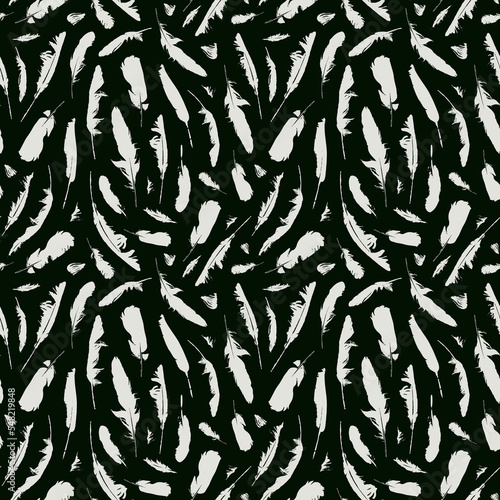 Monochrome seamless pattern with disheveled feathers. Abstract vector background with chaotic scattered bird feathers. White feathers on black backdrop. Suitable for wallpaper, wrapping paper, fabric