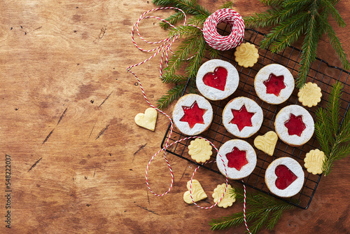 Classic Linzer Christmas Cookies with raspberry or strawberry jam on wooden table photo