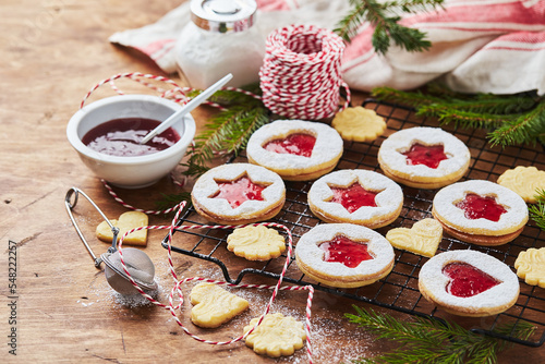 Classic Linzer Christmas Cookies with raspberry or strawberry jam on wooden table photo