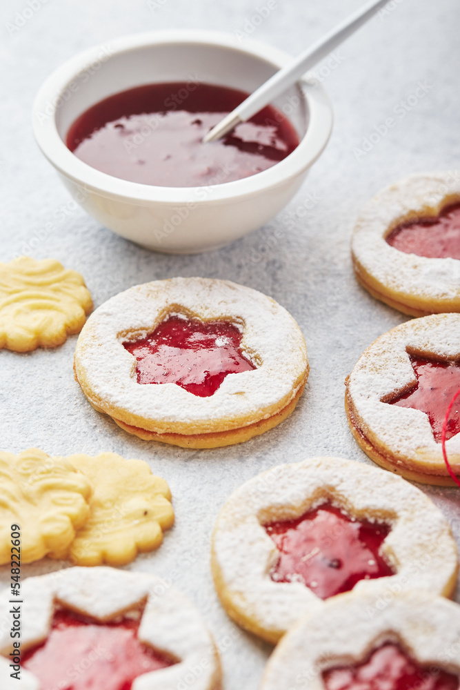 Classic Linzer Christmas Cookies with raspberry or strawberry jam on light background. Classic Linzer Christmas Cookies with raspberry or strawberry jam on light background.