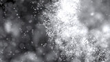 3D rendering of cluster of white particles flitting about on black background with bokeh