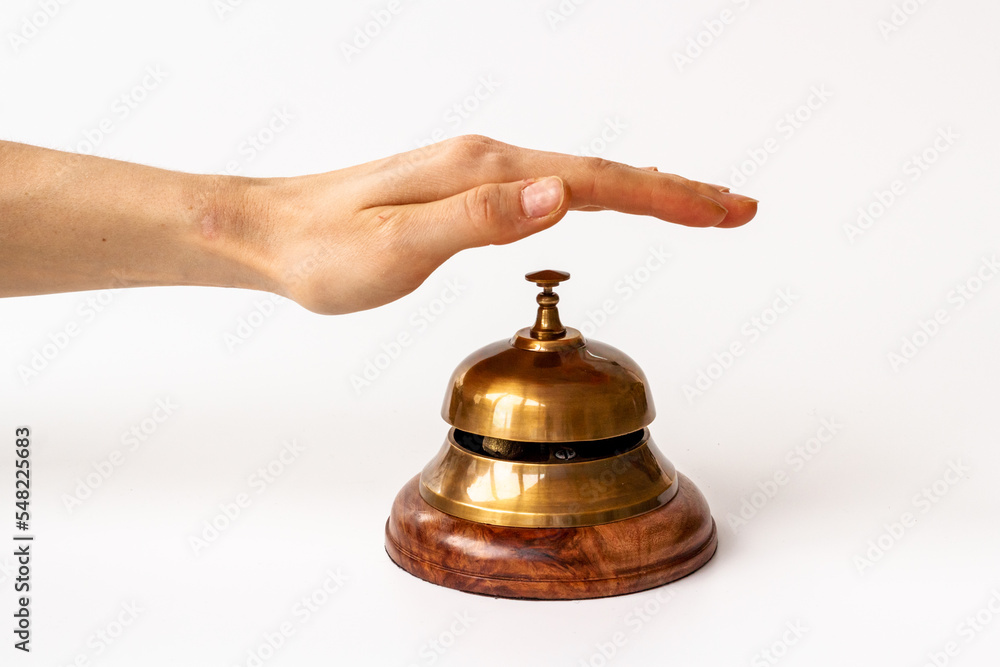 Hand on metal golden service bell. Attention concept Hand on metal golden service bell. Attention concept