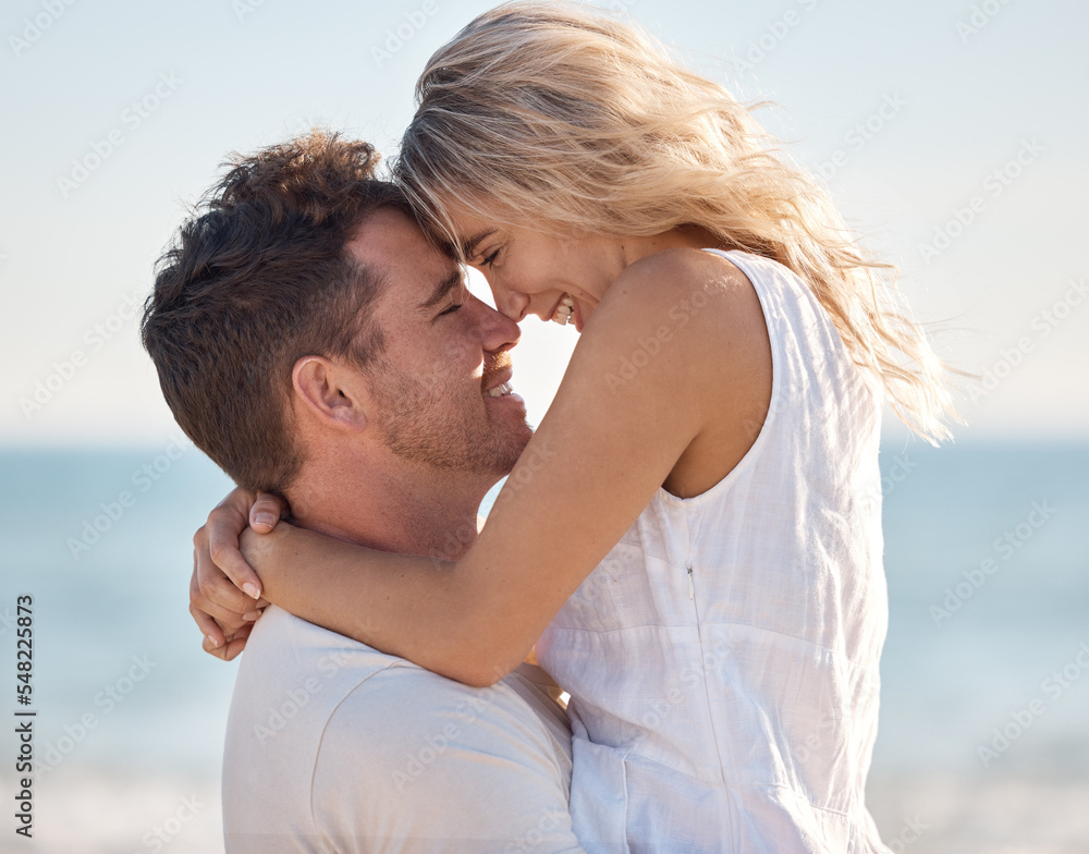 Fototapeta premium Beach, love and couple nose touch with smile for romance, bond and happiness with carrying hug. Partner, holiday and Canada ocean embrace in summer for happy, relaxing and intimate memory.