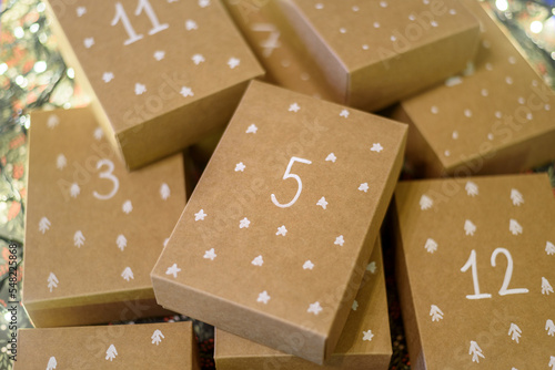 Paper handmade boxes to Christmas Advent Calendar with day numbers and drawn pattern
