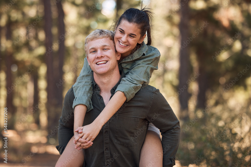Couple, hug and smile for piggyback in nature walk, love and support for fun relationship bonding together. Portrait of happy man carrying woman smiling and enjoying quality time in the outdoors Couple, hug and smile for piggyback in nature walk, love and support for fun relationship bonding together. Portrait of happy man carrying woman smiling and enjoying quality time in the outdoors