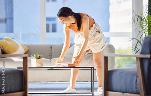 Tableau sur toile Woman, cleaning and books on home table for organisation, happiness and housework in lounge