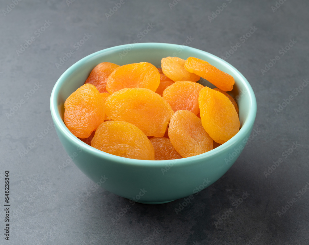 Dried apricots on a bowl over stone background Dried apricots on a bowl over stone background