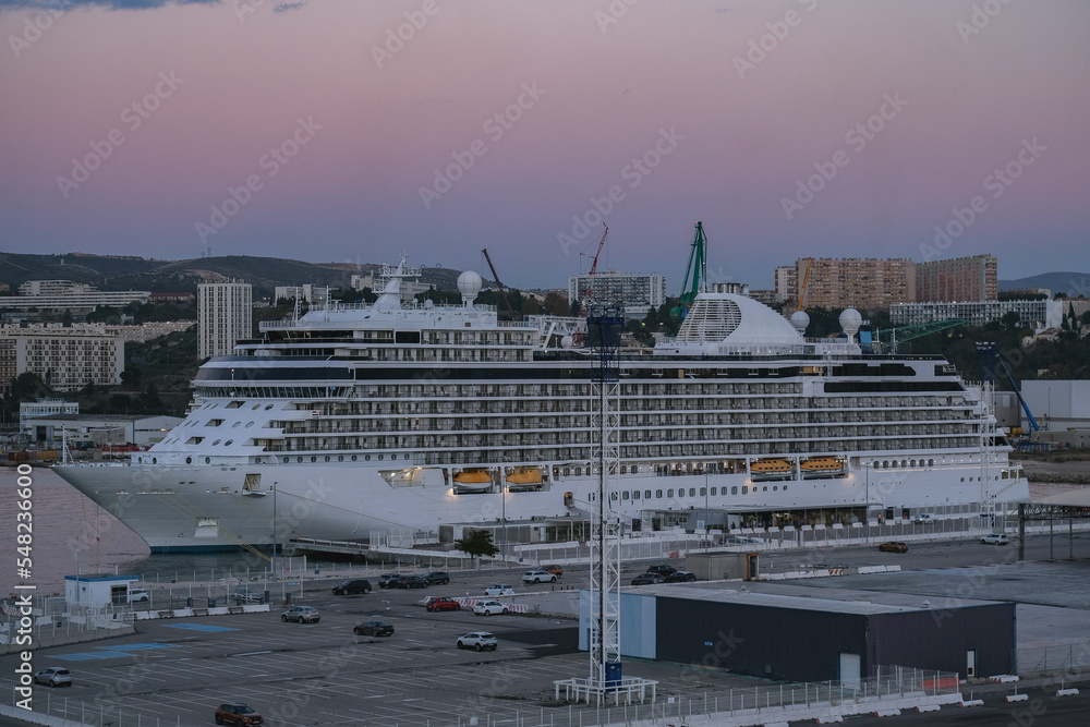 Regent luxury cruiseship or cruise ship liner Splendor arrival into Marseille Provence port during sunrise twilight blue hour Mediterranean cruise dream vacation