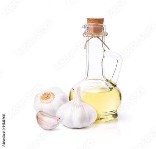 Garlic oil with garlic clove and bulb isolated on white background.