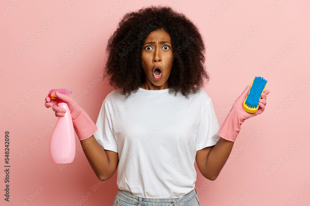 The girl reacts with surprise to the new cleaning agent, she froze with a surprised and shocked look The girl reacts with surprise to the new cleaning agent, she froze with a surprised and shocked look