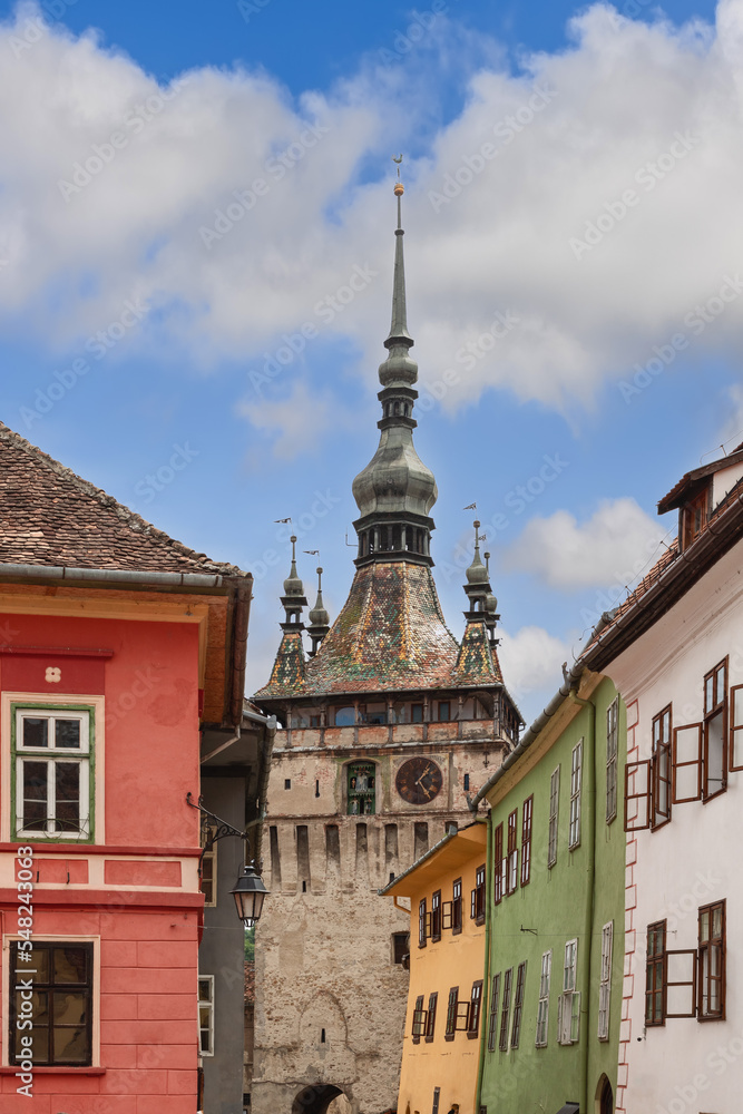 Obraz premium Vertical photo of 64 meters high Clock Tower of Sighisoara (Turnul cu Ceas) is the main entry point to the citadel, purpose was to defend the main gate of the citadel, Transylvania, Romania