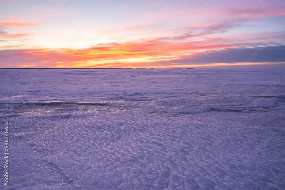 Sunset over the frozen sea. Pörkenäs, Finland.