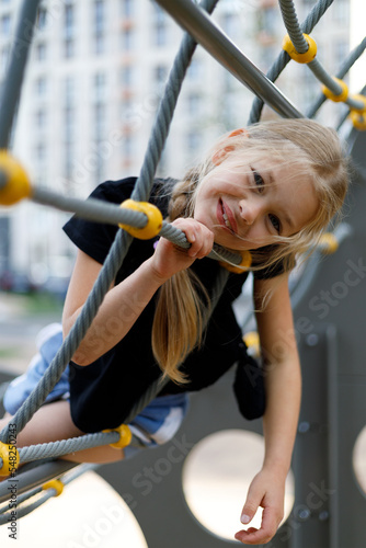 Adorable little girl smiling at the playground, portrait.