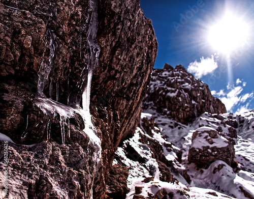 sun over snowy mountain