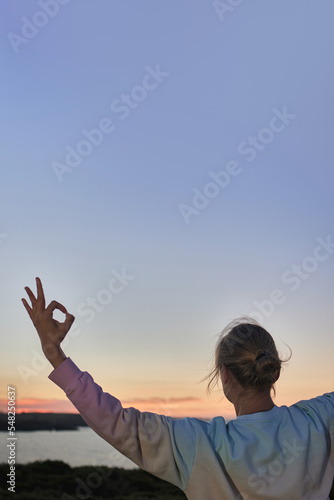 Senior healthy woman in yoga class doing exercise outdoor big copy space