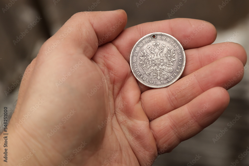 Fototapeta premium Rare vintage silver coin one ruble of Russian Empire in hand